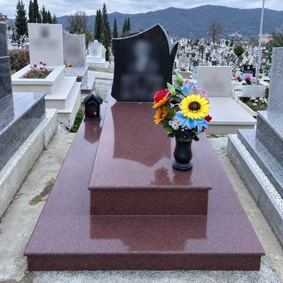 Red granite grave with shaped headstone