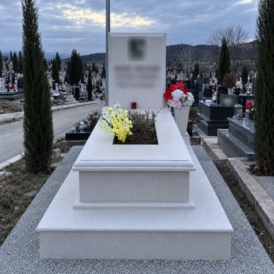 White Vlore marble grave with flowers