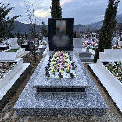 Light granite grave with flowers