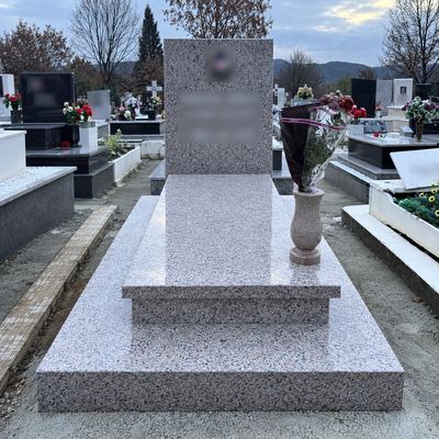 Granite grave with slim headstone