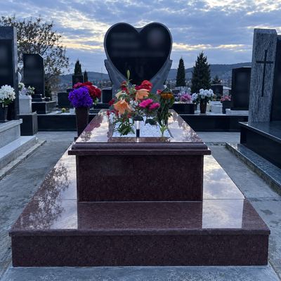 Red granite grave with heart-shaped headstone
